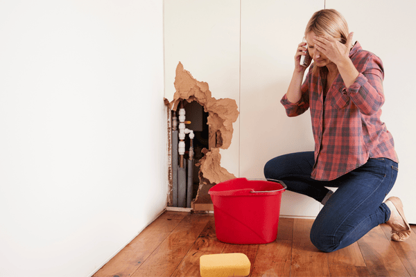 Woman with Burst Pipe Water Damage Phoning for Help